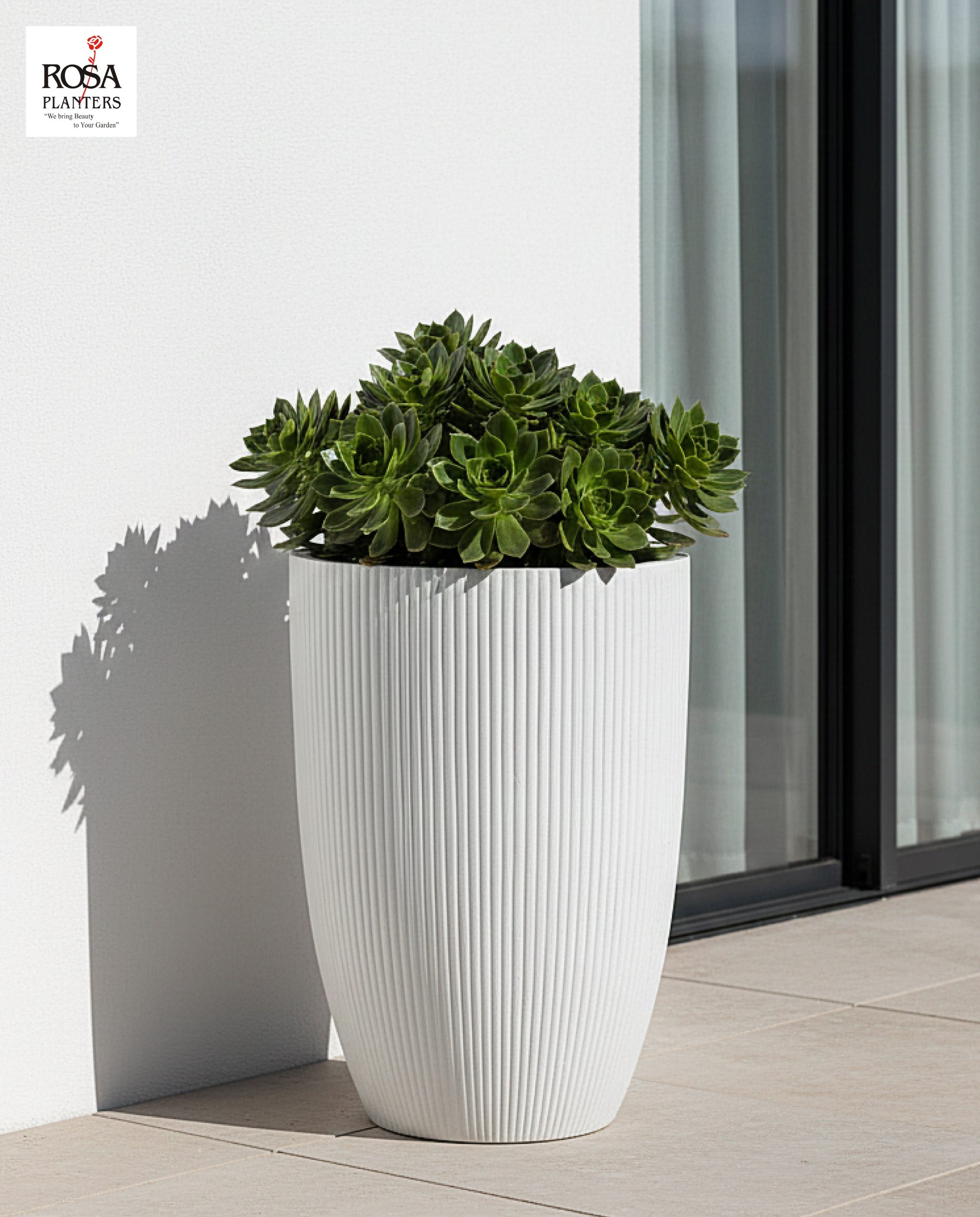 Large polystone decor planters on an outdoor patio showing a durable, weather-resistant finish