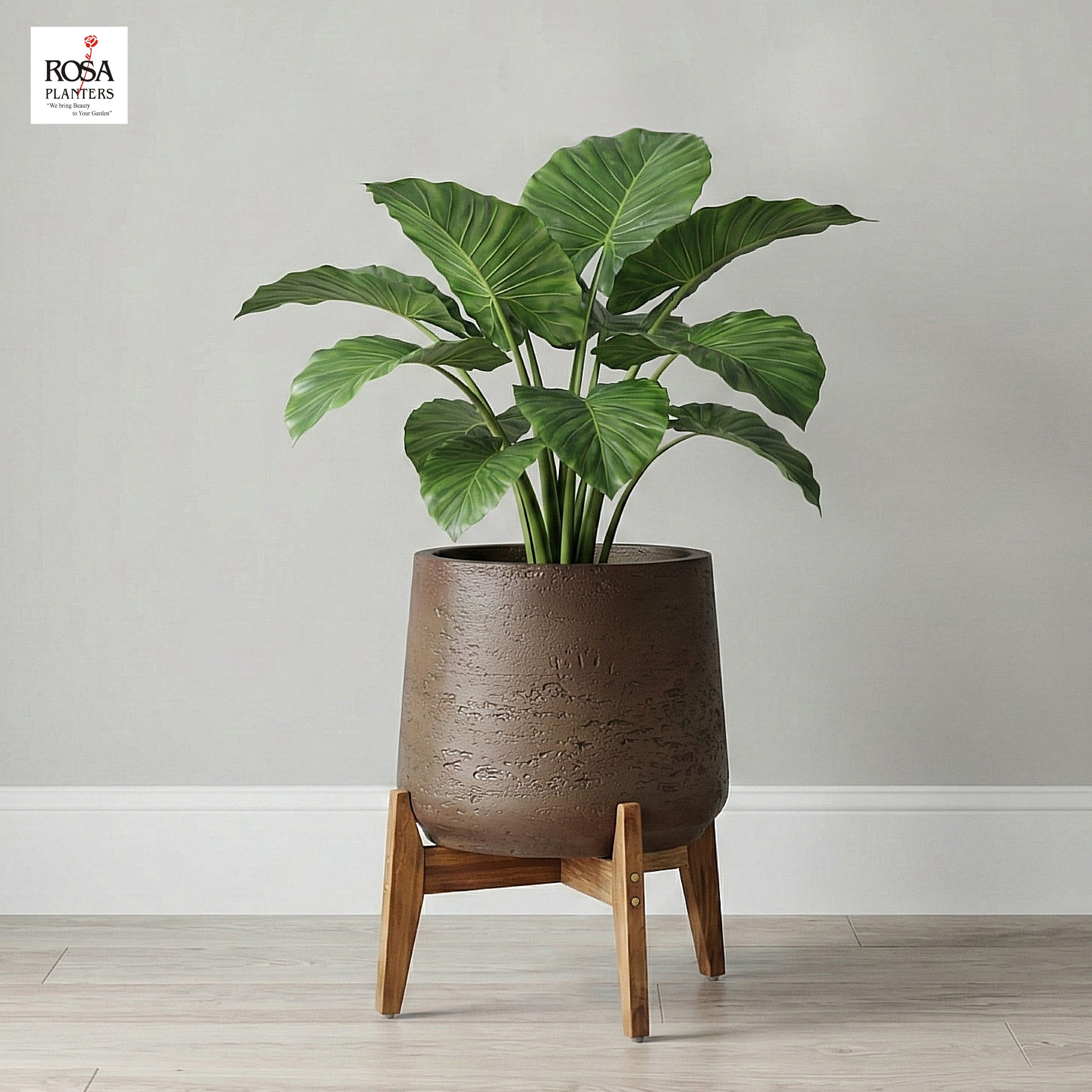 Brown textured polystone planter on a wooden stand holding a large-leaf plant