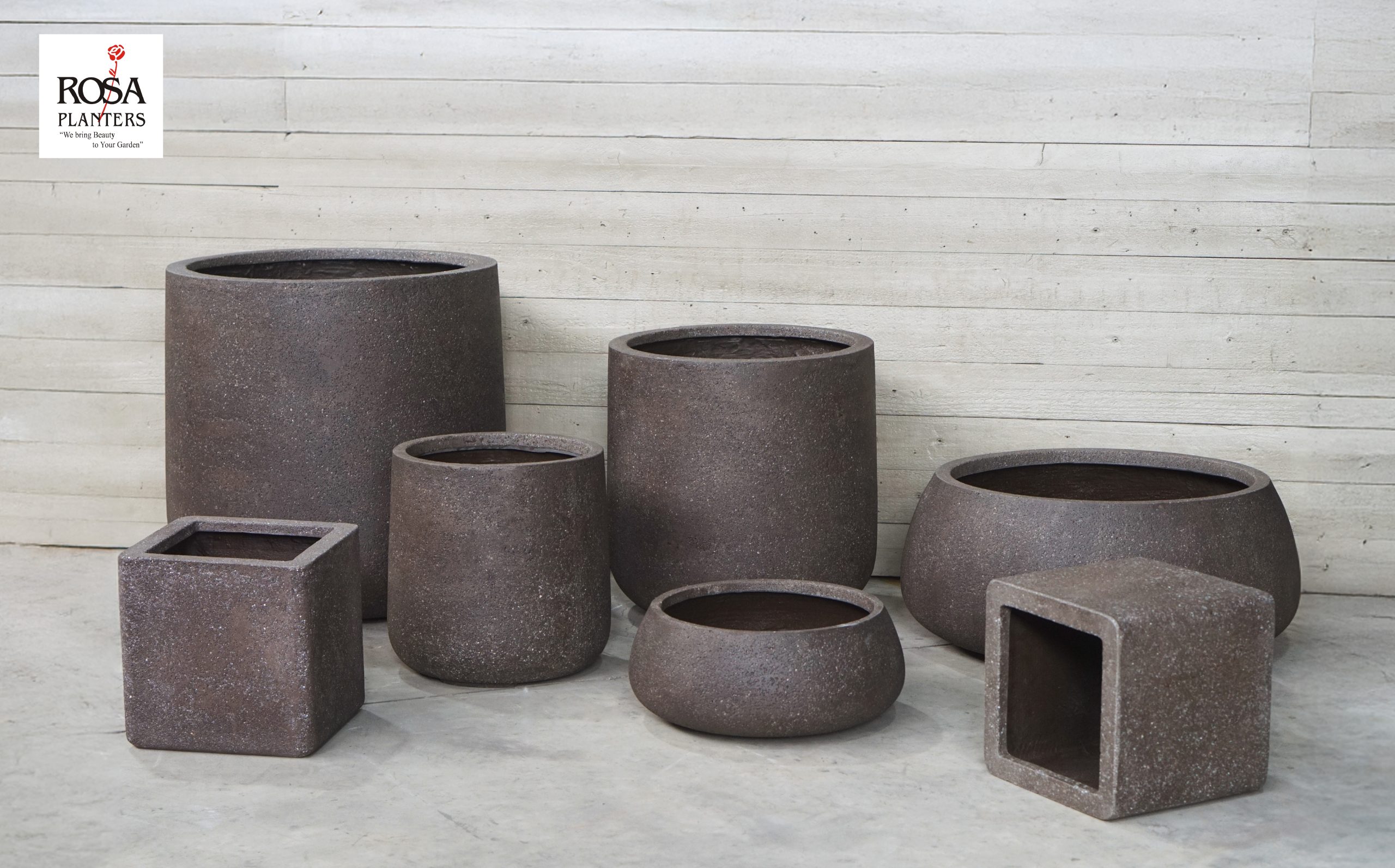 Range of brown speckled polystone planters in cylinder, bowl and square shapes from Rosa Planters